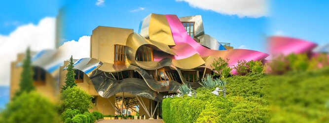 Trip Ayurveda Reisetipps - Marqués de Riscal Design Hotel, Bilbao, Elciego, Spanien. Fantastisch galaktisch, unverkennbar ein Werk von Frank O. Gehry. Inmitten idyllischer Weinberge in der Rioja Region des Baskenlandes, bezaubert das schimmernde Bauobjekt mit einer Struktur bunter, edel glänzender verflochtener Metallbänder. Glanz im Baskenland - Es muss etwas ganz Besonderes sein. Emotional, zukunftsweisend, einzigartig. Denn in dieser Region, etwa 133 km südlich von Bilbao, sind Weingüter normalerweise nicht für die Öffentlichkeit zugänglich.